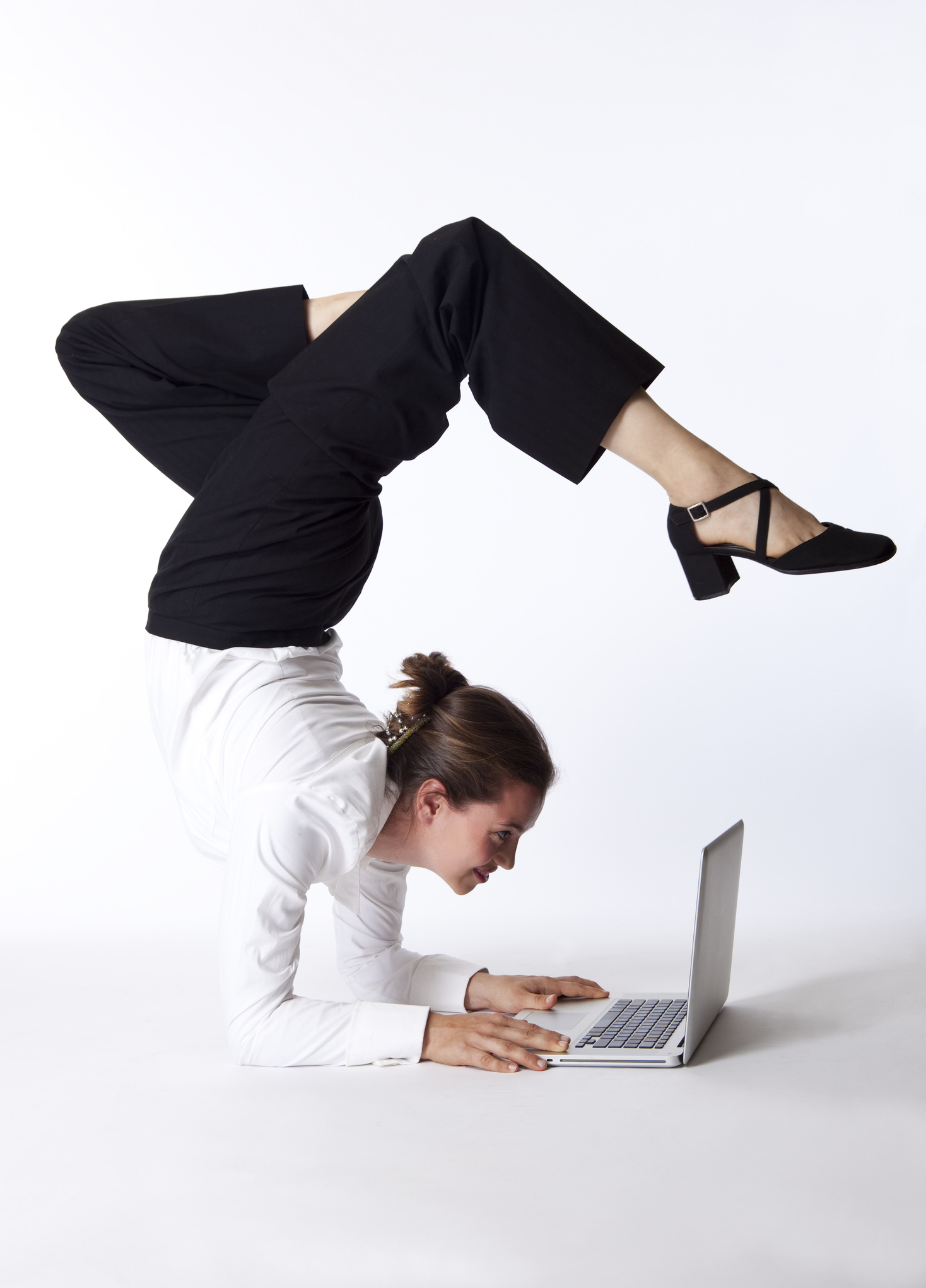 businesswoman doing yoga on laptop